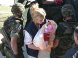  A Kosovska Mitrovica hospital nurse holds a newly born baby from the village Laplje Selo, near Pristina, Saturday 20 March 2004. KFOR units evacuated the village following the recent outbreak of ethnic violence in the Kosovo province.  EPA